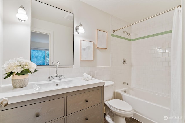 full bathroom with toilet, shower / tub combo, vanity, and tile walls