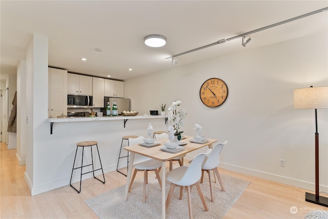 dining room with light hardwood / wood-style flooring