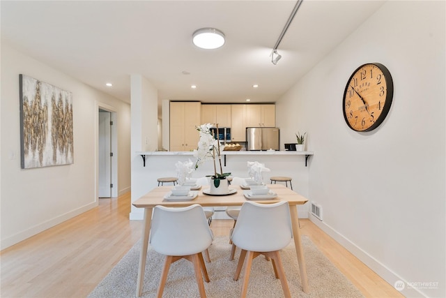 dining space with light wood-type flooring