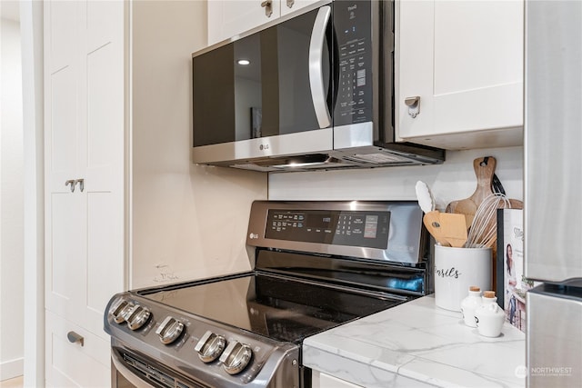 kitchen featuring white cabinets and appliances with stainless steel finishes