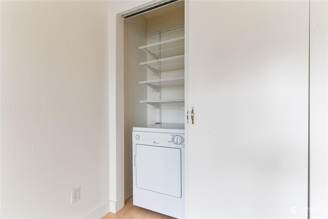 washroom with washer / dryer and light hardwood / wood-style floors