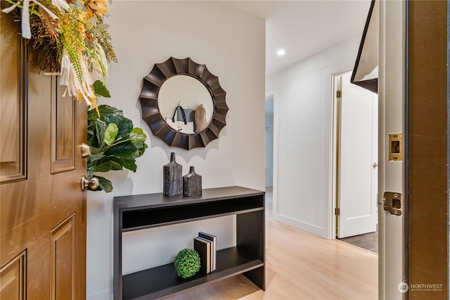 hallway with light hardwood / wood-style floors