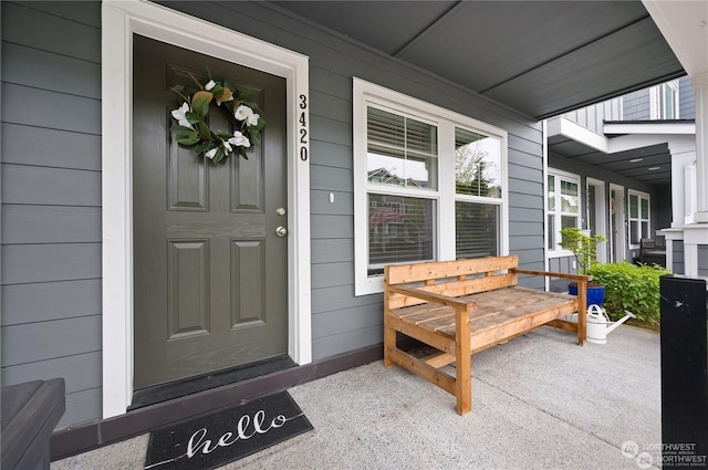 view of exterior entry featuring a porch