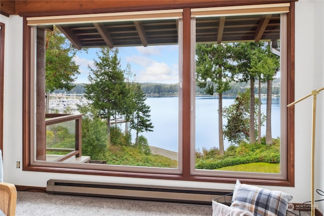 interior space featuring a water view, a baseboard radiator, and carpet floors