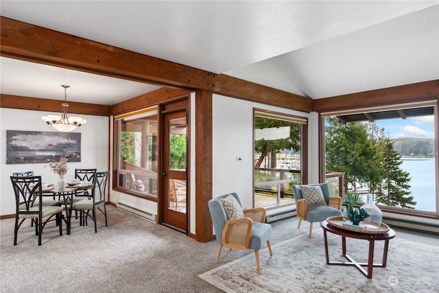 carpeted living room with a baseboard radiator, a water view, a chandelier, and vaulted ceiling