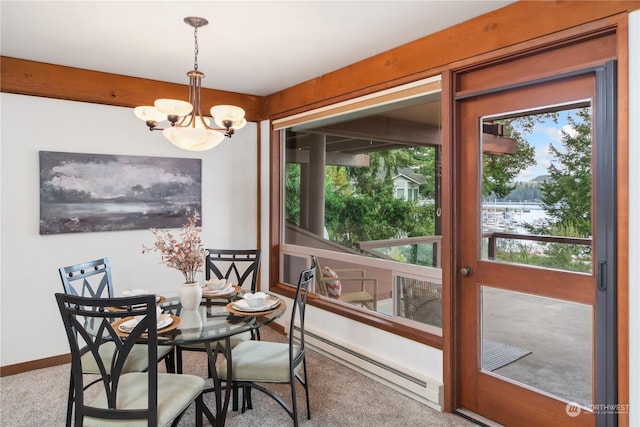 dining area featuring a baseboard heating unit, a notable chandelier, plenty of natural light, and carpet