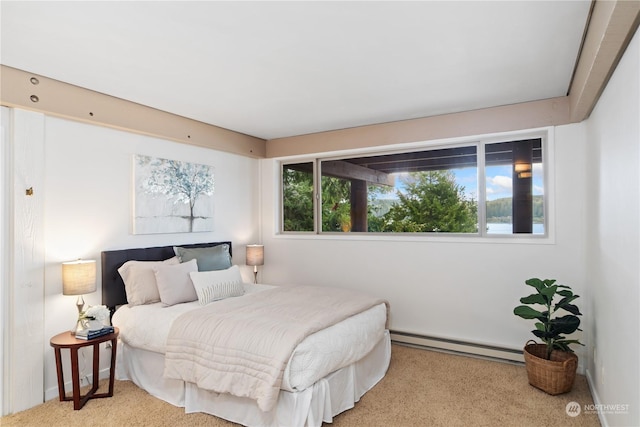 bedroom with a baseboard radiator and light carpet