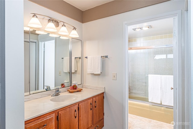 bathroom featuring enclosed tub / shower combo and vanity