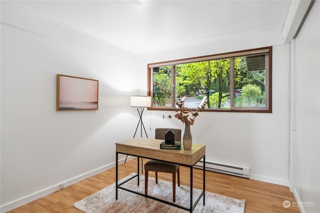 office area with hardwood / wood-style floors and baseboard heating