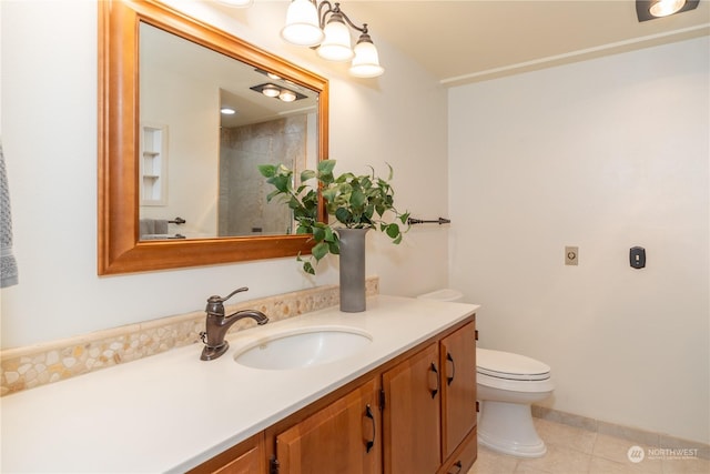 bathroom featuring tile patterned floors, vanity, and toilet