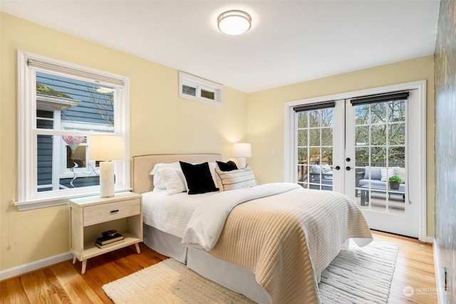 bedroom featuring access to outside, french doors, and light hardwood / wood-style flooring