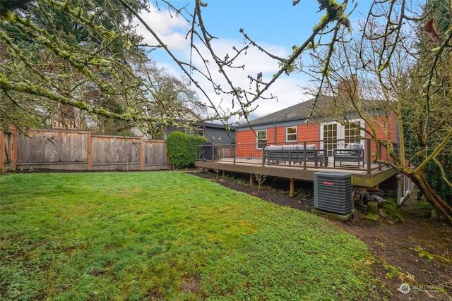 view of yard featuring a wooden deck and central air condition unit