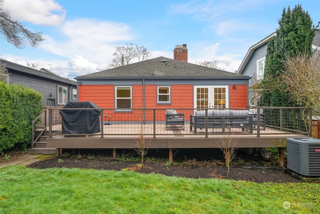 back of house with central AC unit, a deck, a lawn, and outdoor lounge area