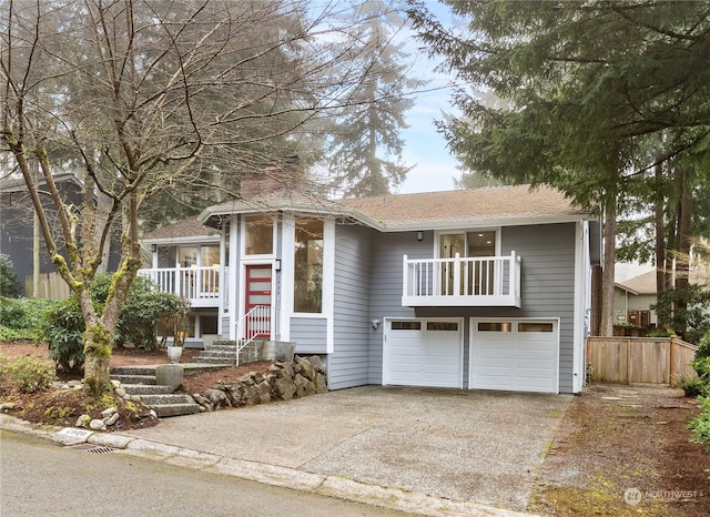 raised ranch featuring a balcony and a garage