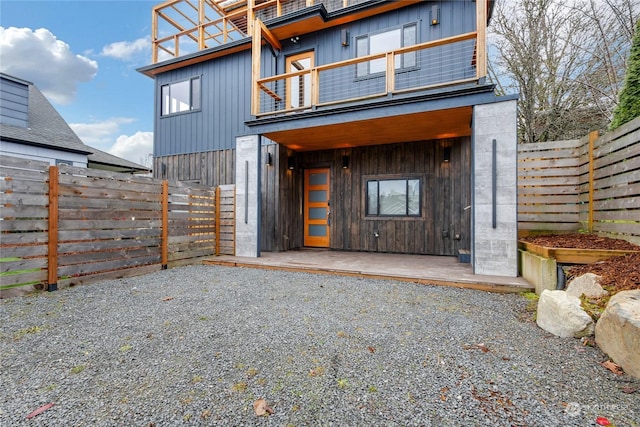 entrance to property with a balcony and a patio