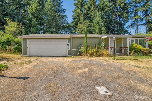 ranch-style home featuring a garage and covered porch