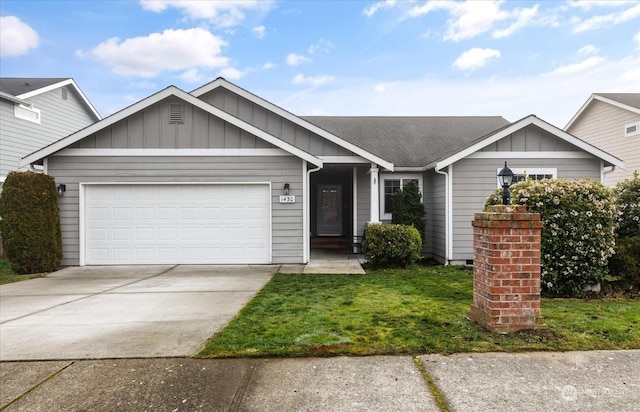 view of front of property with a front yard and a garage