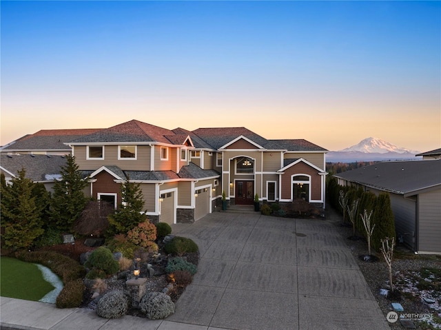 view of front facade featuring a garage and a mountain view