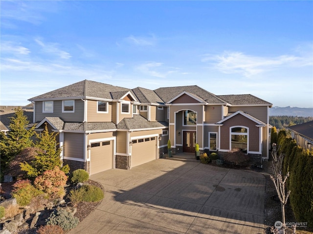 view of front of home featuring a garage and a mountain view