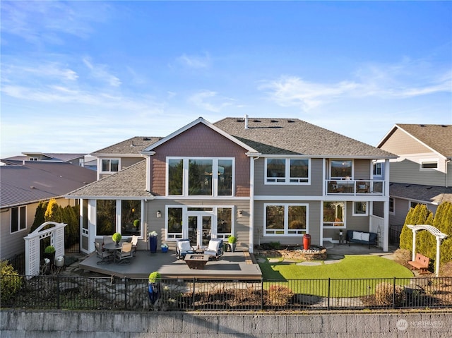 rear view of house with a patio, outdoor lounge area, and a lawn