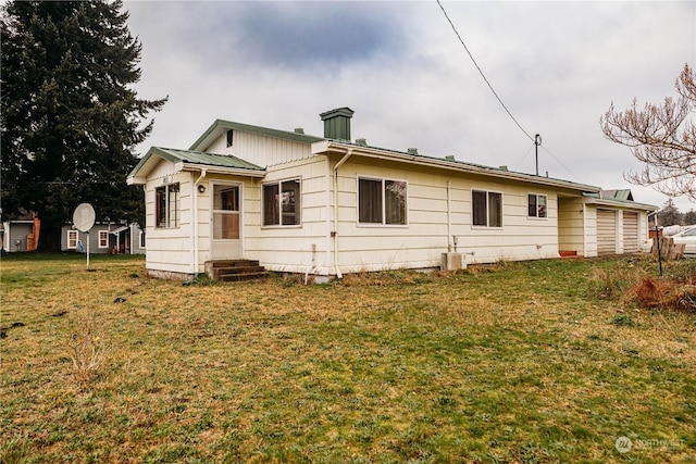 back of house with a lawn