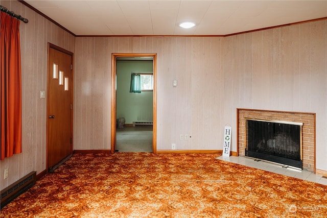 unfurnished living room with a baseboard radiator, ornamental molding, carpet, and a fireplace