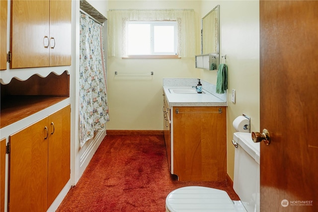 bathroom with toilet, vanity, and curtained shower