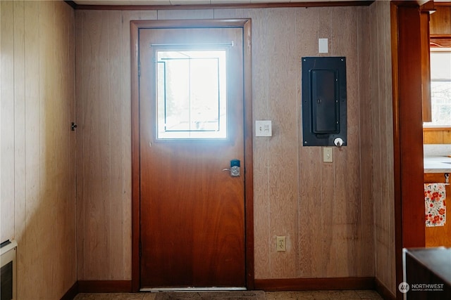 doorway to outside with wooden walls and electric panel