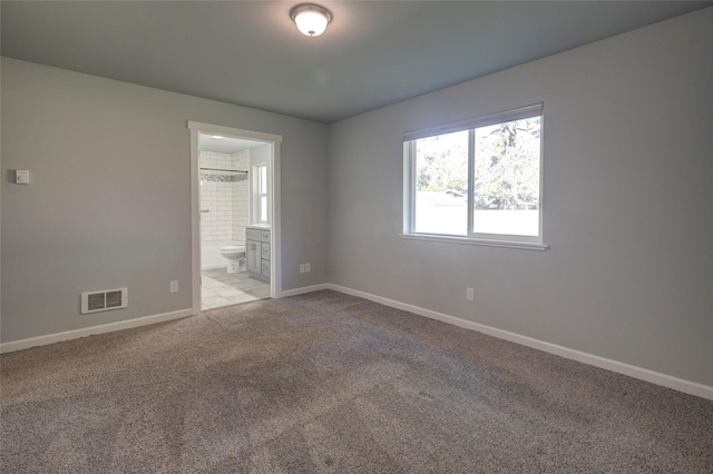 unfurnished room with baseboards, visible vents, and light colored carpet