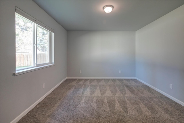 spare room with carpet floors and baseboards