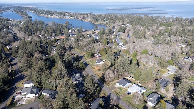 aerial view featuring a forest view and a water view