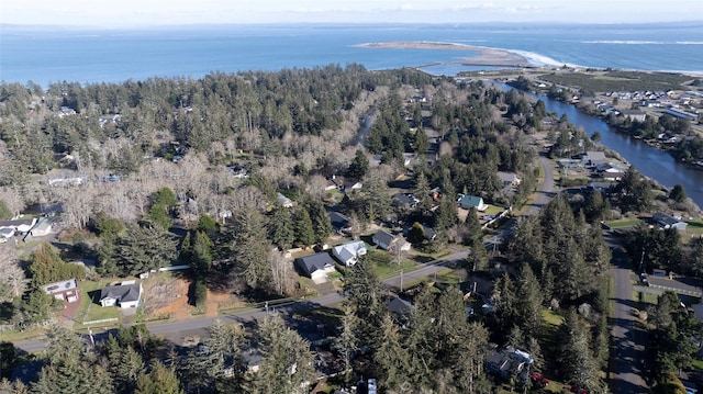 aerial view with a water view and a forest view