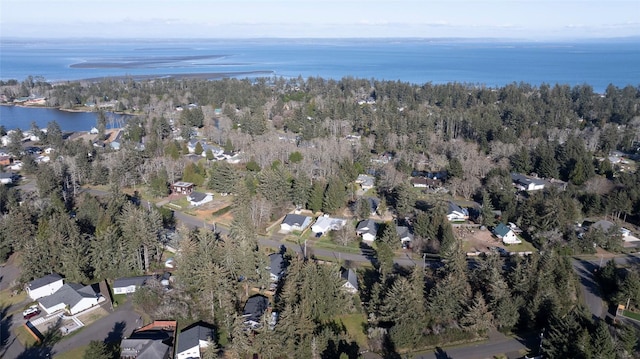 aerial view featuring a forest view and a water view