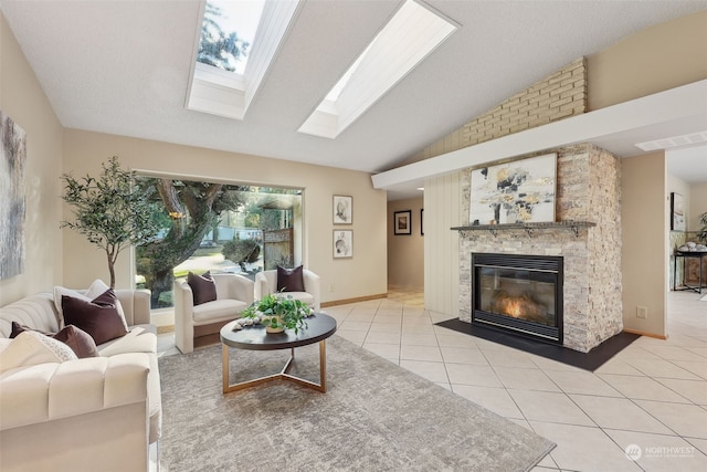 living room featuring light tile patterned floors, vaulted ceiling, and a stone fireplace