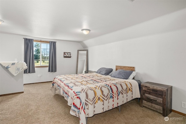 bedroom featuring carpet and lofted ceiling