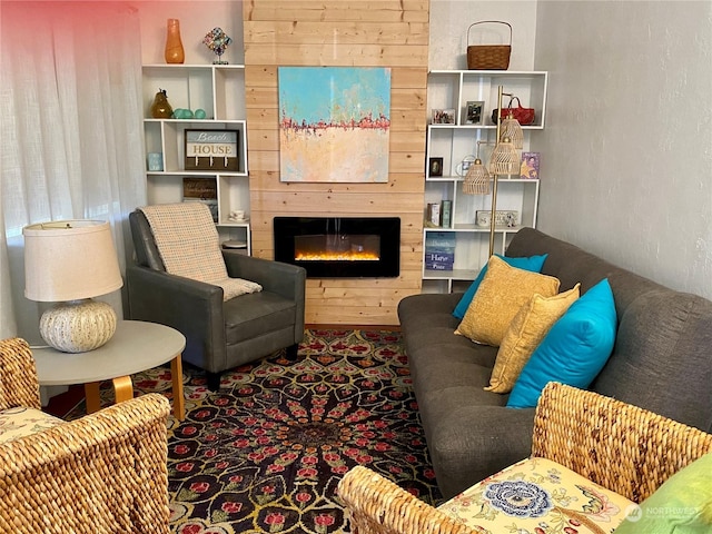 living room with a large fireplace and wooden walls