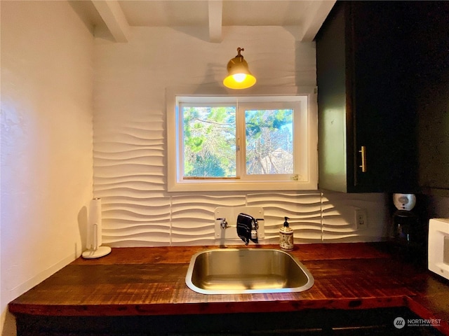 kitchen with beam ceiling and sink