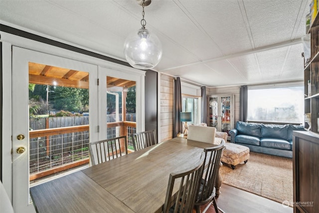 dining space featuring wood-type flooring and a textured ceiling