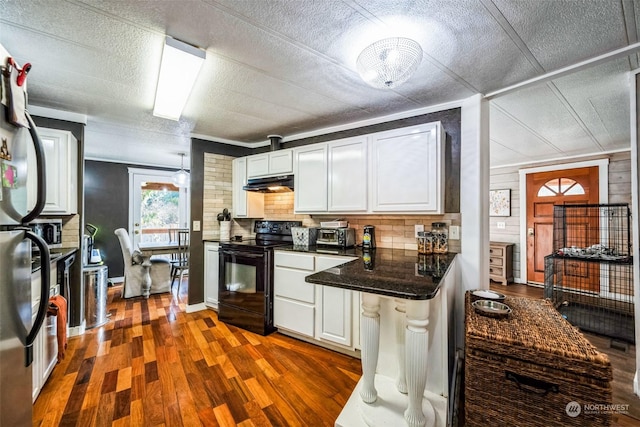 kitchen with white cabinets, ornamental molding, backsplash, dark hardwood / wood-style flooring, and black range with electric cooktop