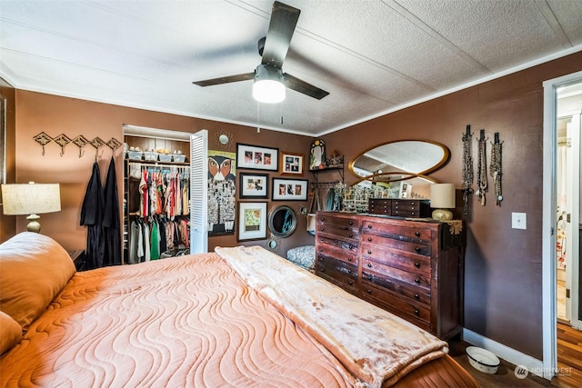 bedroom featuring a closet, ceiling fan, and ornamental molding