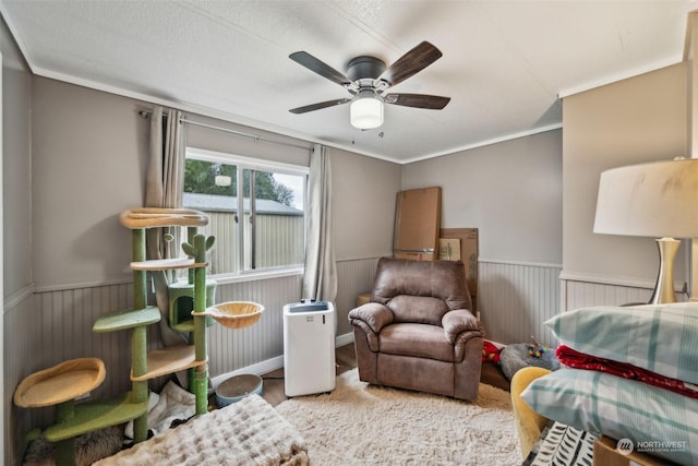 sitting room with ornamental molding, ceiling fan, and light wood-type flooring