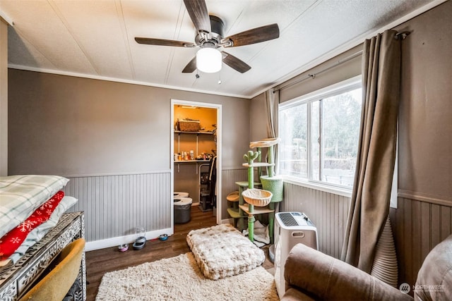 sitting room with ceiling fan, crown molding, and dark hardwood / wood-style floors