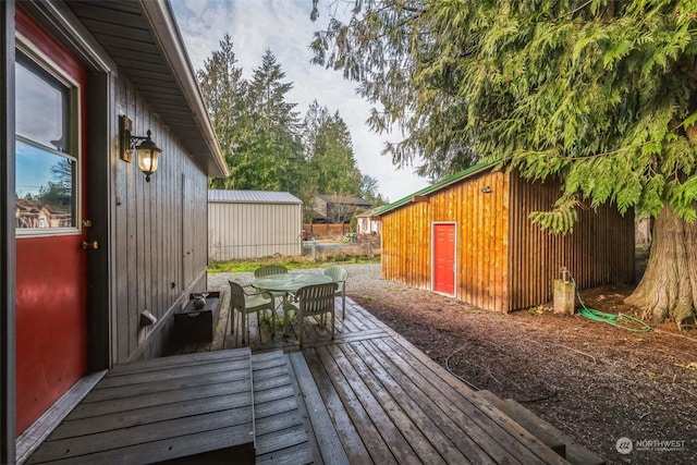 wooden terrace featuring an outdoor structure