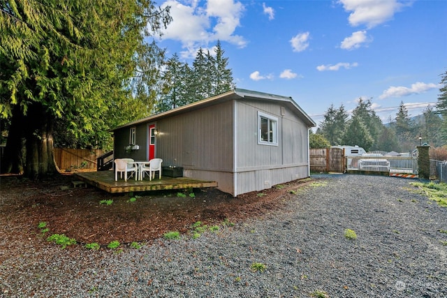 view of home's exterior featuring a wooden deck