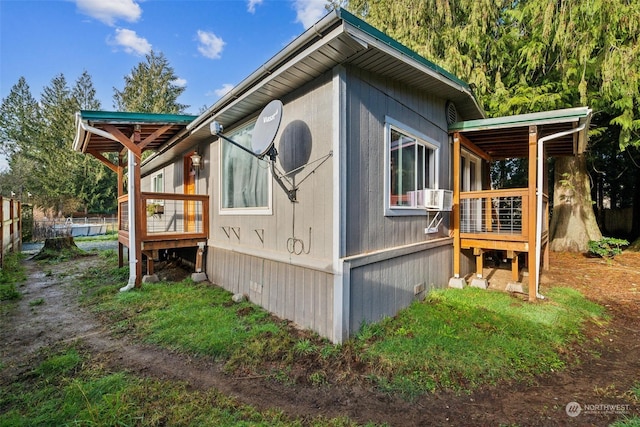 view of side of home featuring cooling unit