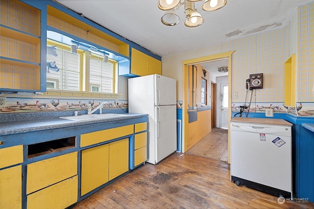 kitchen featuring sink, wood-type flooring, white appliances, and plenty of natural light