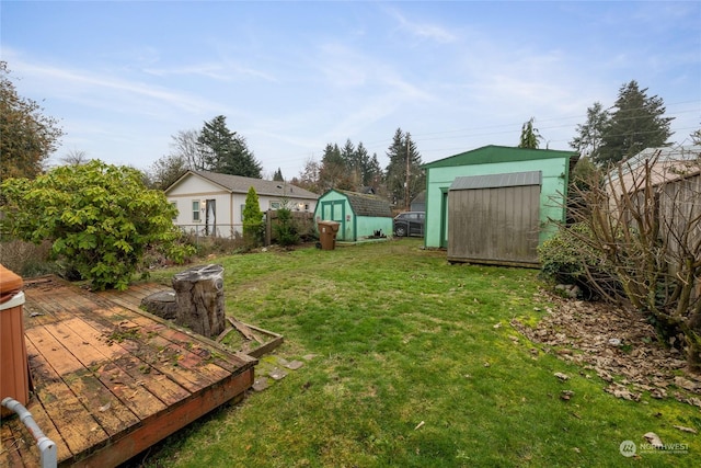 view of yard with a deck and a storage shed