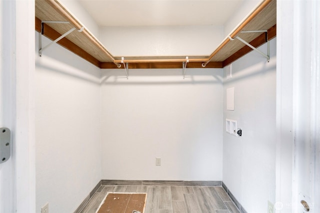 walk in closet featuring wood finished floors