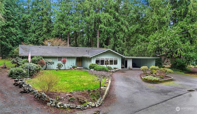 ranch-style home featuring a front yard and a carport