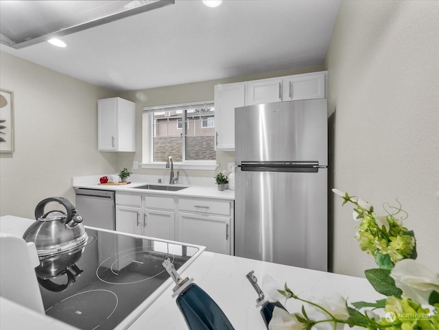 kitchen featuring sink, white cabinets, and appliances with stainless steel finishes